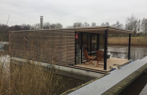 Rustersiel Boat Rental | Houseboat HT 4; with fireplace for 4 people in an idyllic location in Wilhelmshaven