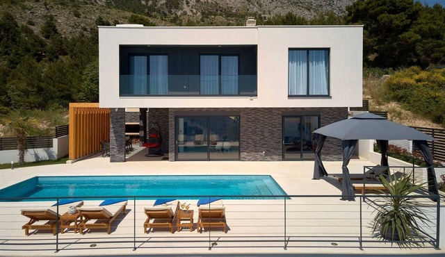 A modern villa with a pool and an amazing sea view