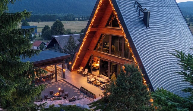 Luxury mountain villa with pool, sauna and forest views.