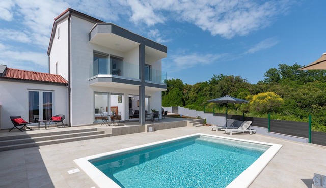 Modern vacation home with pool and sea view.