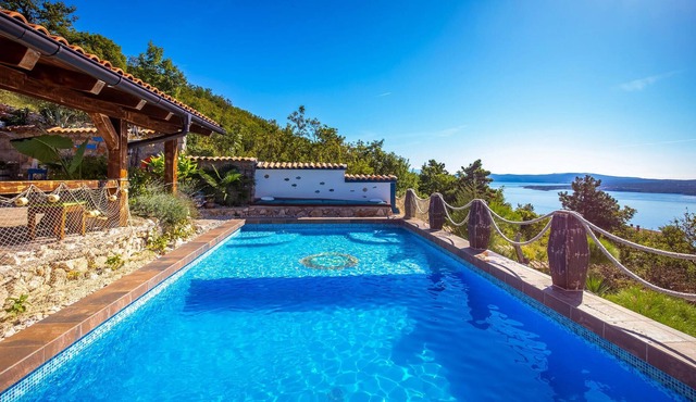 On a hill with a magnificent panoramic view of the sea and the islands is located this beautiful vac