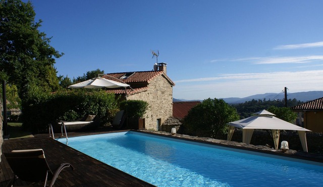Stone house with pool and garden.