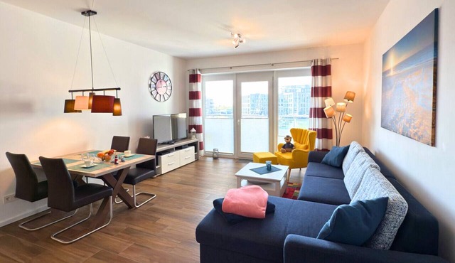 Stylish "Ankerplatz" Vacation Rental in Bremerhaven. Balcony with a beach chair and a breathtaking view of the harbor. Ultimate sleeping comfort in a high-quality box spring bed. Home Charging Station for Electric Cars